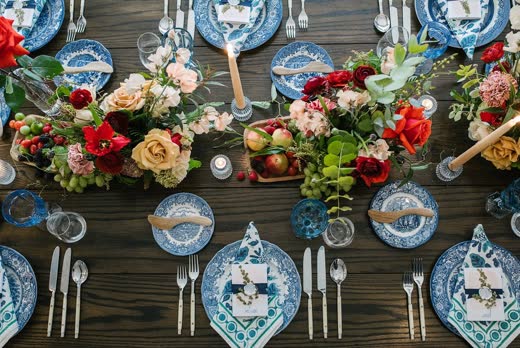 Blue-and-white plates under red and orange flowers