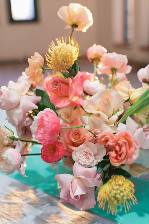 Poppies and peach blooms in a low arrangement