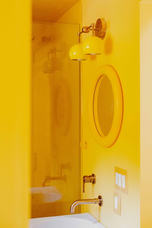 A sculptural yellow chair in a yellow room