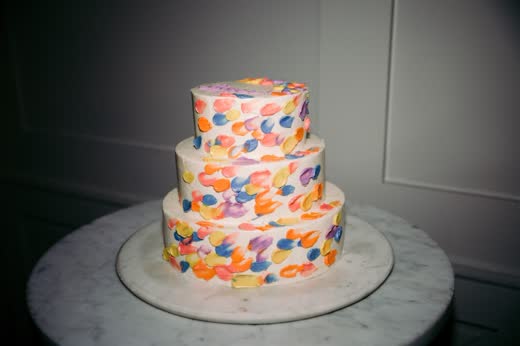 A cake painted in confetti colours
