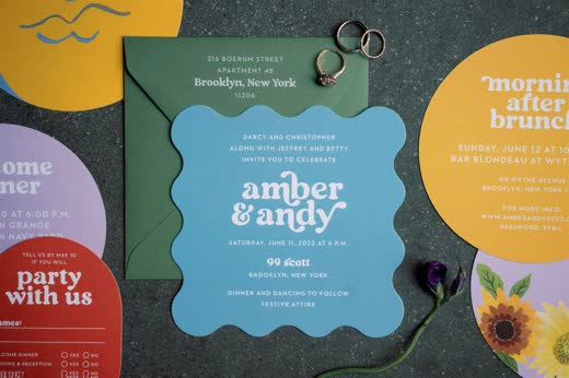 A colourful wedding invitation suite